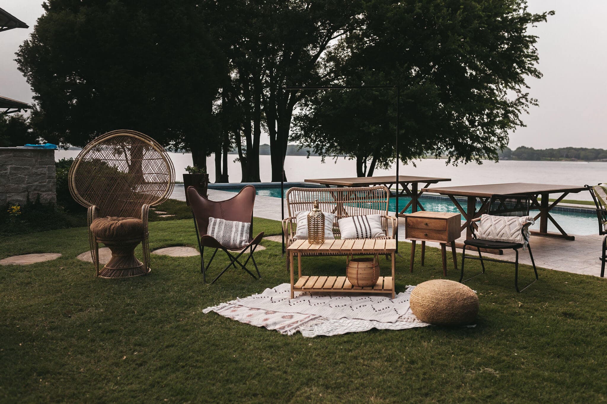 A cozy outdoor seating area with various chairs and a table near a pool.